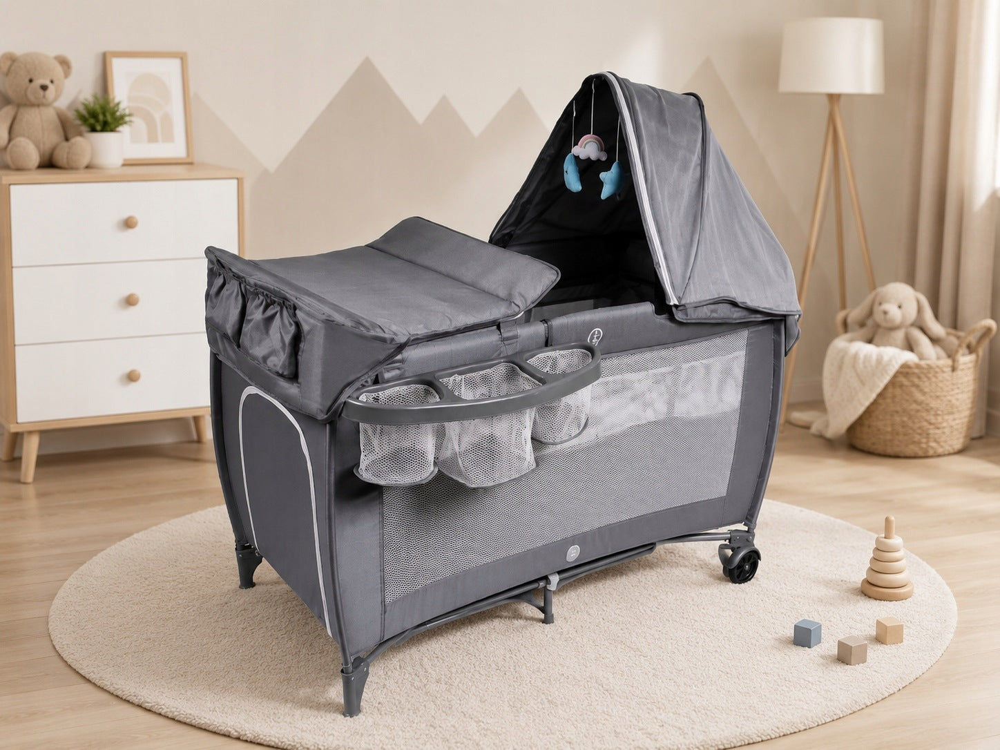 Grey folding travel cot with changing table up to 15 kg