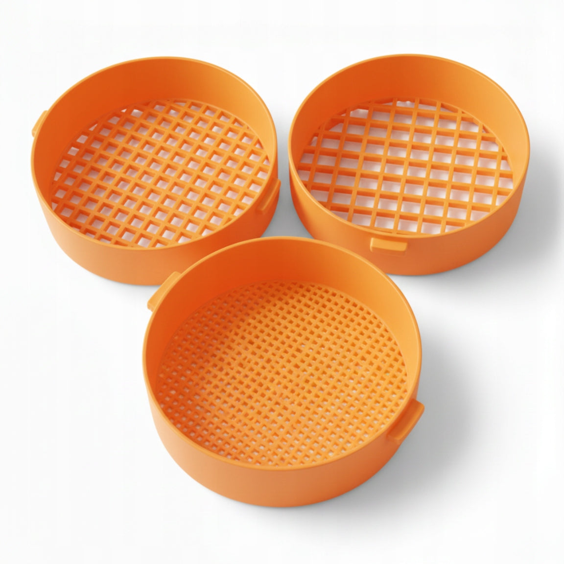 Set of orange strainers for sifting sand on the beach for children