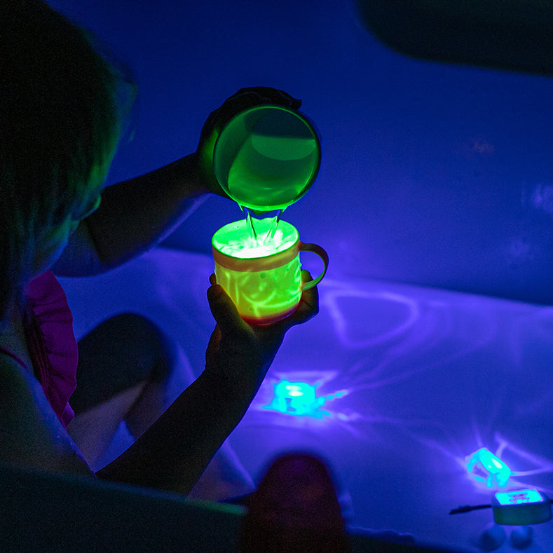 Glo Pals sensory cubes glowing in water Pippa green