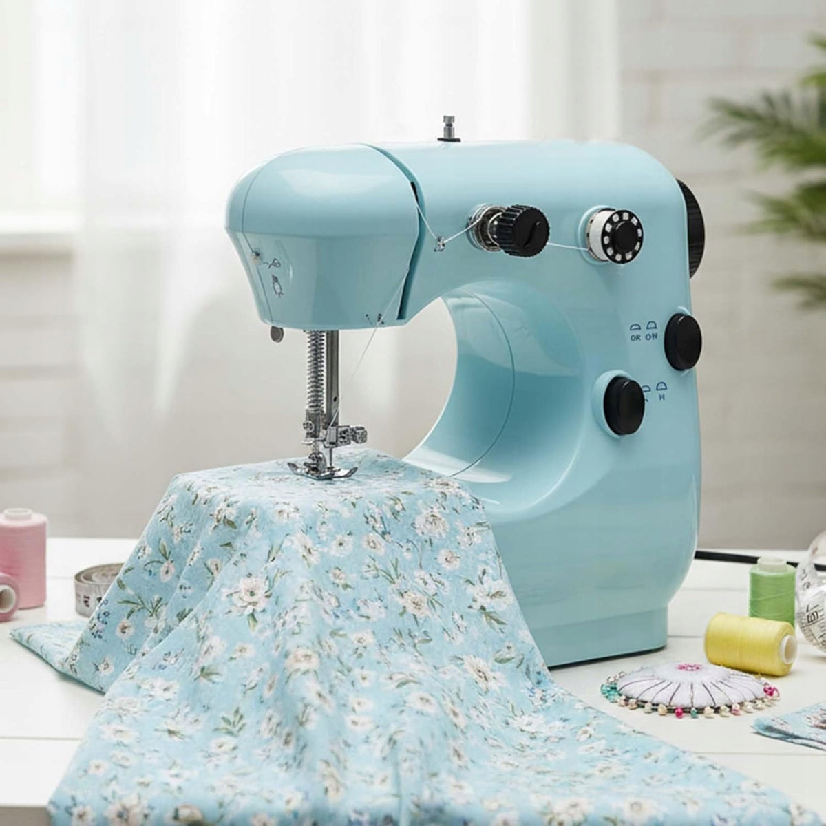 SET! Small, portable two-speed sewing machine, with pull-out table! Dominant color white